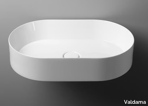 TRACK - Countertop oval single ceramic washbasin _ Valdama