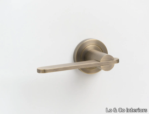 INTERSECT - Brass door handle on rose _ Lo & Co Interiors