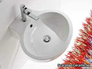 PLANET - Wall-mounted oval ceramic washbasin _ Scarabeo Ceramiche